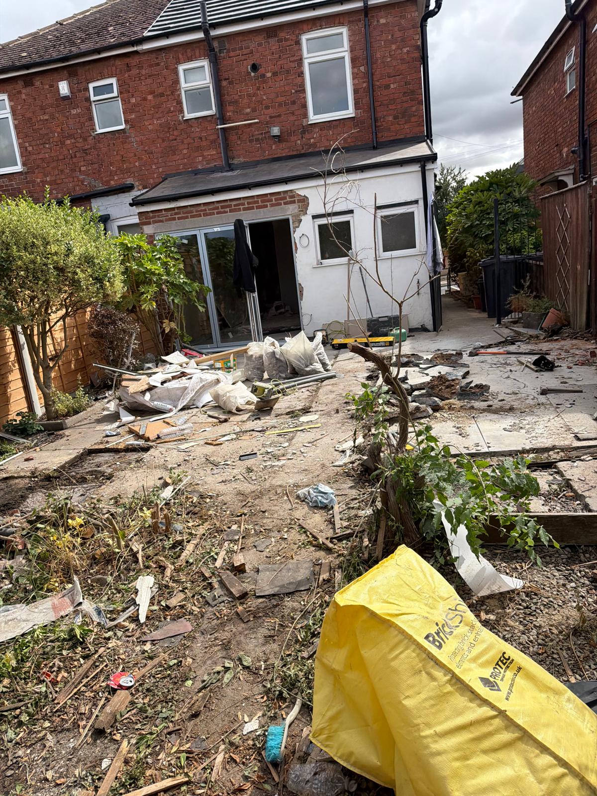Damaged garden section before construction work